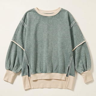 Green and beige sweatshirt flat lay